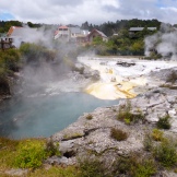Looking through the steam to see the crystal-clear pools of boiling-hot mineral water at Whakarewarewa Thermal Village in Rotorua, North Island